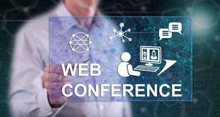 Man touching a web conference concept on a touch screen with a penの写真素材