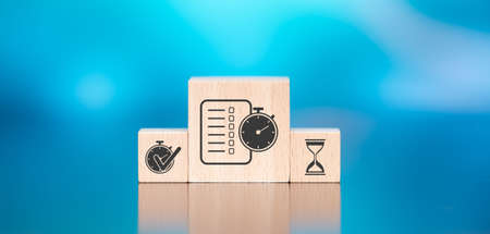 Wooden blocks with symbol of time management concept on blue background