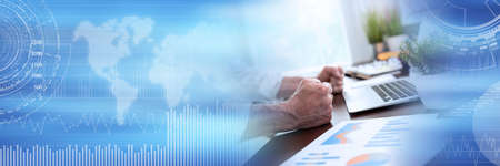 Angry businessman hitting his desk with his clenched fists; panoramic banner