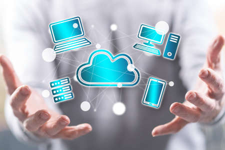 Cloud computing concept above the hands of a man in background