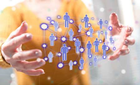 Social network concept between hands of a woman in background