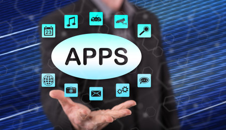 Apps concept above the hand of a man in backgroundの写真素材