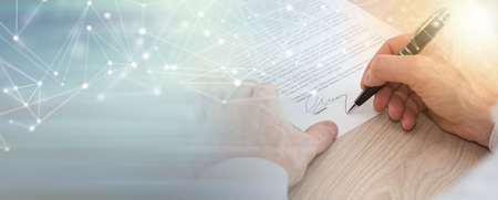 Man signing a legal document; panoramic banner