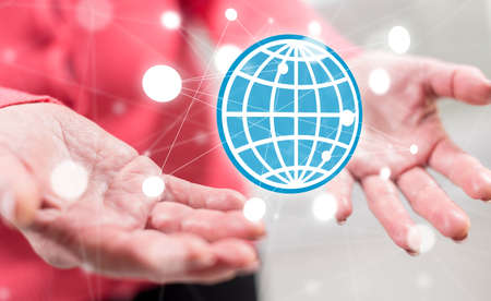 Global business concept above the hands of a woman in backgroundの写真素材