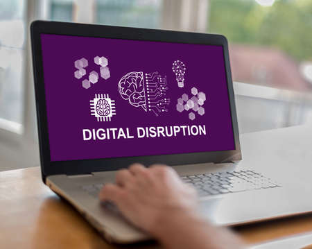 Man using a laptop with digital disruption concept on the screenの写真素材