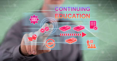 Man touching a continuing education concept on a touch screen with his fingerの写真素材