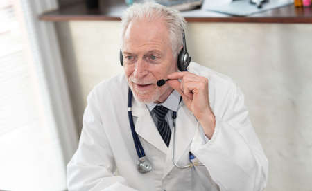 Portrait of senior doctor during online medical consultation