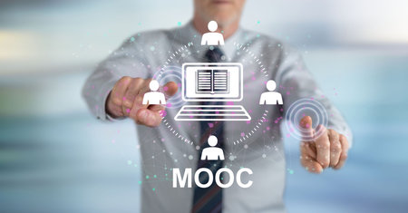 Man touching a mooc concept on a touch screen with his fingersの写真素材