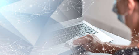 woman disinfecting laptop keyboard with antibacterial wipe; prevention of virus and bacteria...
