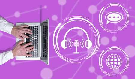 Top view of hands using laptop with symbol of podcast conceptの写真素材