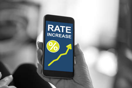 Smartphone screen displaying a rate increase conceptの写真素材