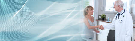 Doctor shaking hands with his female patient; panoramic bannerの写真素材