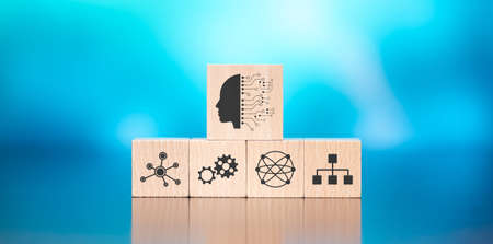 Wooden blocks with symbol of machine learning concept on blue background