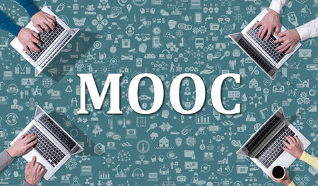 Mooc concept with top view of hands using laptop on icons backgroundの写真素材