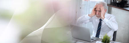 exhausted businessman sitting at desk; panoramic bannerの写真素材