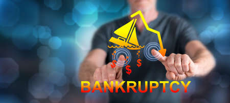 Man touching a bankruptcy concept on a touch screen with his fingersの写真素材