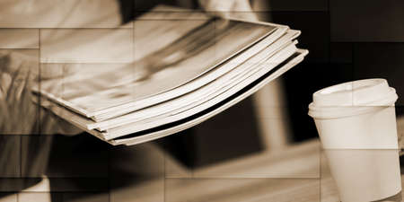 Male hands holding a stack of magazines, geometric patternの写真素材