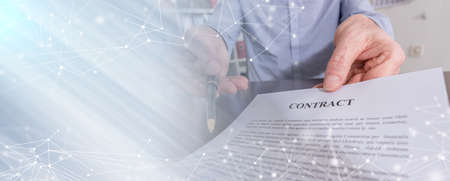 Businessman offering a pen for signing a contract; panoramic banner