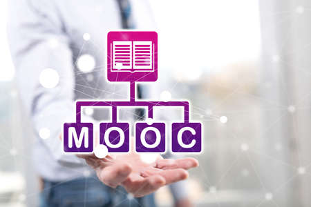 Mooc concept above the hand of a man in backgroundの写真素材