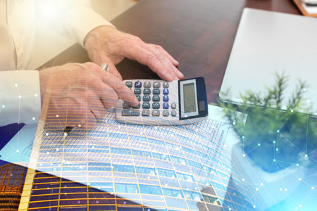 Male hands using calculator. concept of finance and economy; multiple exposureの写真素材