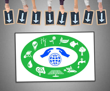 Hands holding writing slates with arrows pointing on environment protection conceptの写真素材