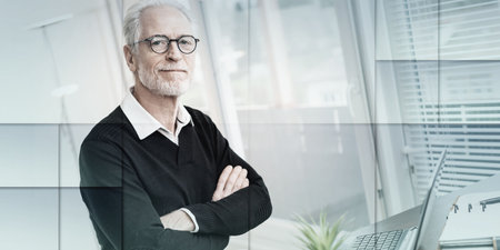 Portrait of senior businessman with arms crossed, geometric patternの写真素材
