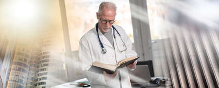 Senior doctor reading a textbook in clinic; multiple exposure