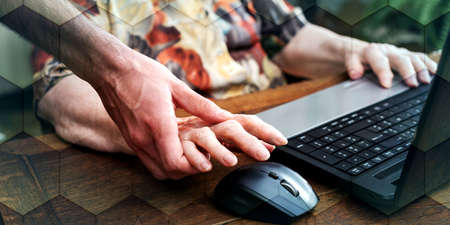 Old woman learning to use a laptop, geometric patternの写真素材