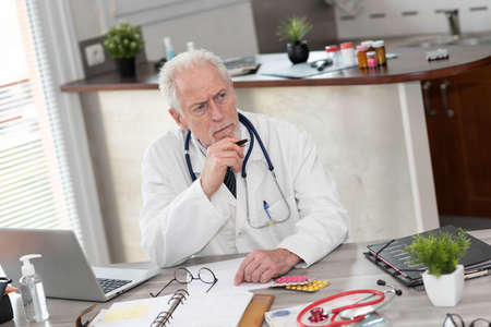 Portrait of thoughtful doctor in medical officeの写真素材