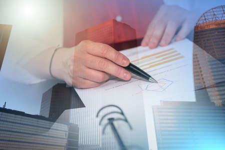 Businesswoman analyzing marketing data; multiple exposure