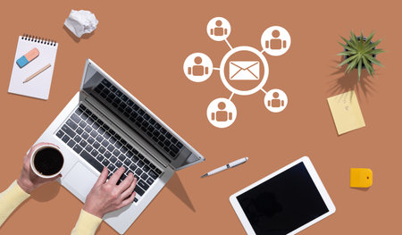 Top view of hands using laptop with symbol of email marketing conceptの写真素材