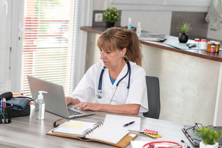 Female doctor using laptop in medical office