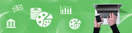 Top view of hands using laptop and mobile phone with symbol of budget concept