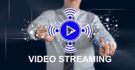 Man touching a video streaming concept on a touch screen with his fingers