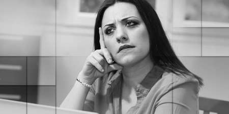 Portrait of young thoughtful businesswoman looking up, geometric patternの写真素材