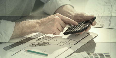 Architect working on a project and using a calculator, geometric patternの写真素材