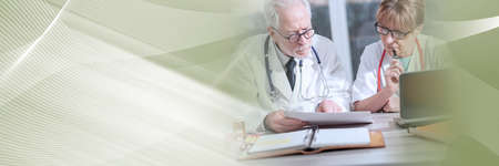 Two doctors discussing about medical results in clinic; panoramic bannerの写真素材