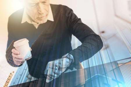 senior businessman checking time on his wrist watch; multiple exposure