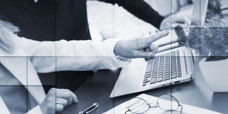 Two business people working together in office, geometric patternの写真素材