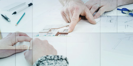 Architect showing house plans to his client, geometric pattern