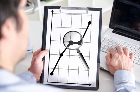 Man holding a clipboard with business analysis conceptの写真素材