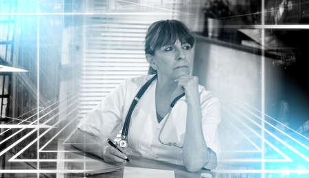 Portrait of thoughtful female doctor in medical office; light effect; multiple exposureの写真素材