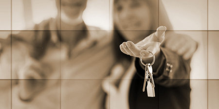 Happy senior couple showing house keys, light effect, geometric patternの写真素材