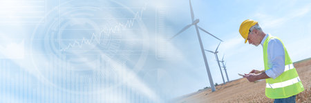 Electrical engineer using digital tablet for wind turbine inspection; panoramic banner