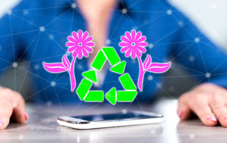 Smartphone with recycling concept between hands of a woman in background