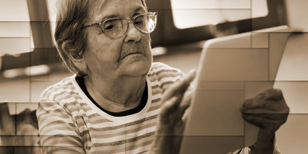 Elderly woman using a digital tablet, geometric pattern