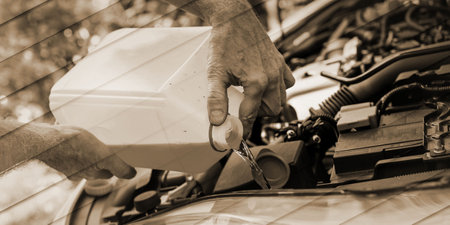 Hands of mechanic pouring windscreen washer in a car, geometric patternの写真素材