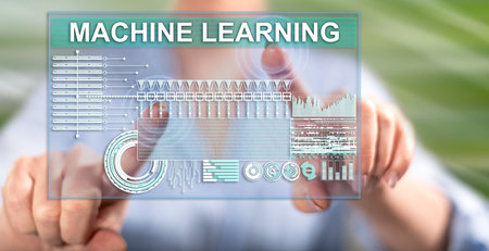 Woman touching a machine learning concept on a touch screen with her fingersの写真素材