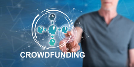 Man touching a crowdfunding concept on a touch screen with his fingerの写真素材