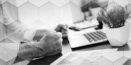 Angry businessman hitting his desk with his clenched fists, geometric pattern